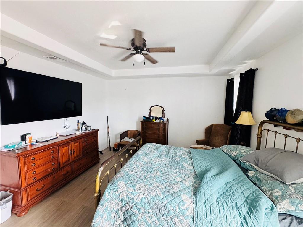 22417 Carrizales Road, Unit SERVICE Edinburg, TX 78542 - Photo 10 of 28 a bedroom with two beds and a flat screen tv