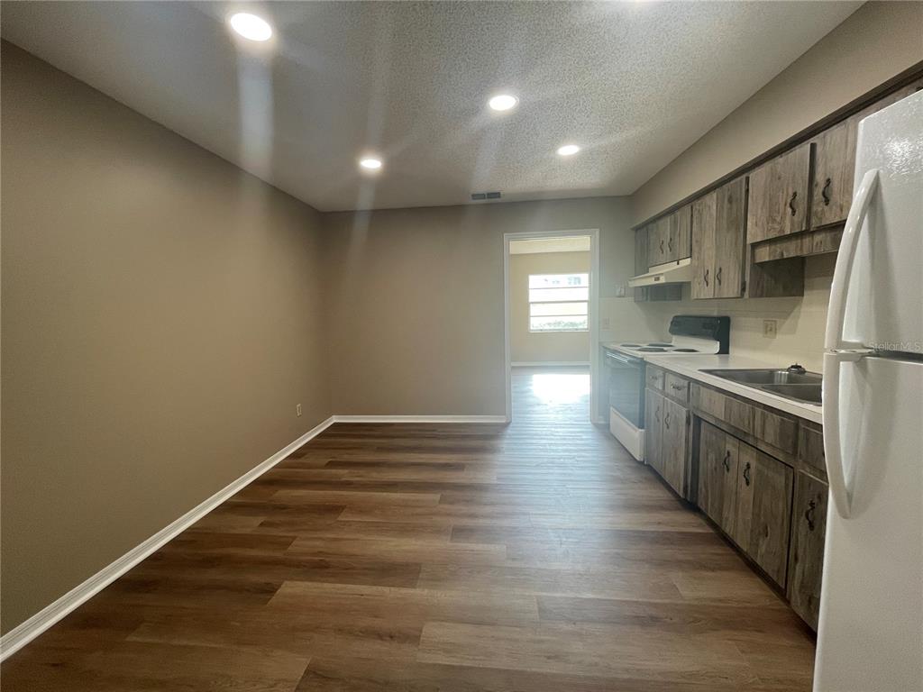 1350 South Alto Verde Terrace, Unit A Inverness, FL 34452 - Photo 12 of 14 a kitchen with stainless steel appliances granite countertop a stove and a refrigerator