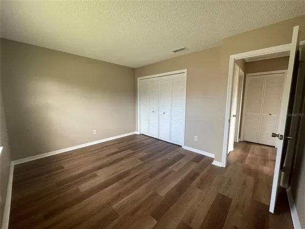 a view of an empty room and wooden floor