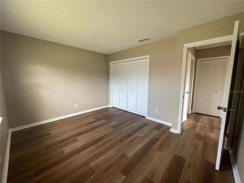 1350 South Alto Verde Terrace, Unit A Inverness, FL 34452 - Photo 8 of 14 a view of an empty room and wooden floor