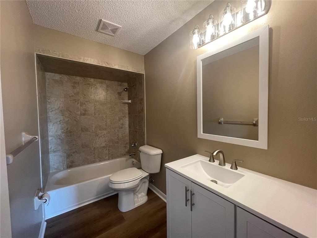 1350 South Alto Verde Terrace, Unit A Inverness, FL 34452 - Photo 10 of 14 a bathroom with a sink a toilet and shower
