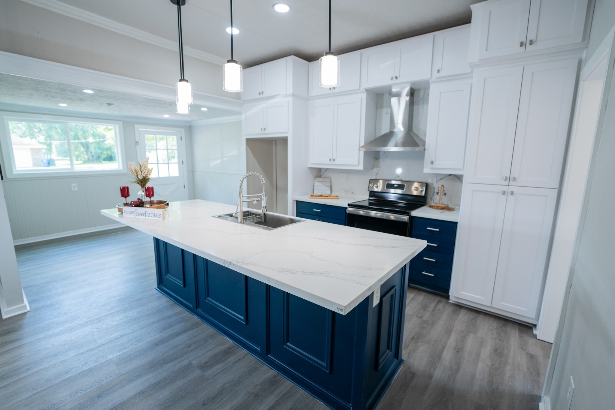 2145 16th Street Hempstead, TX 77445 - Photo 11 of 43 a kitchen with stainless steel appliances a sink stove and wooden floor
