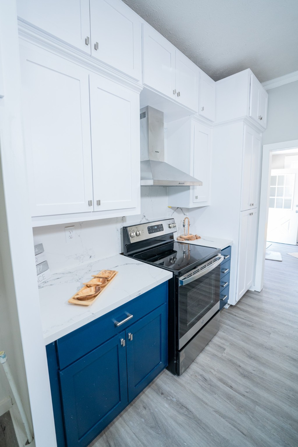 2145 16th Street Hempstead, TX 77445 - Photo 13 of 43 a kitchen with stainless steel appliances granite countertop a sink dishwasher stove and white cabinets with wooden floor
