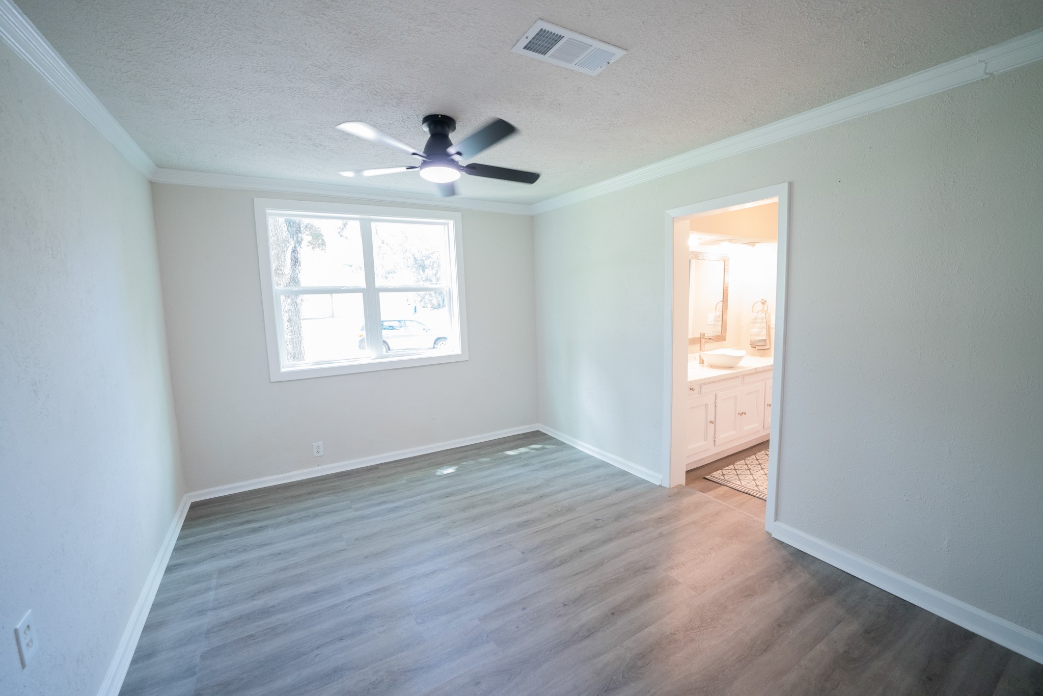 2145 16th Street Hempstead, TX 77445 - Photo 16 of 43 a view of an empty room with wooden floor and a window