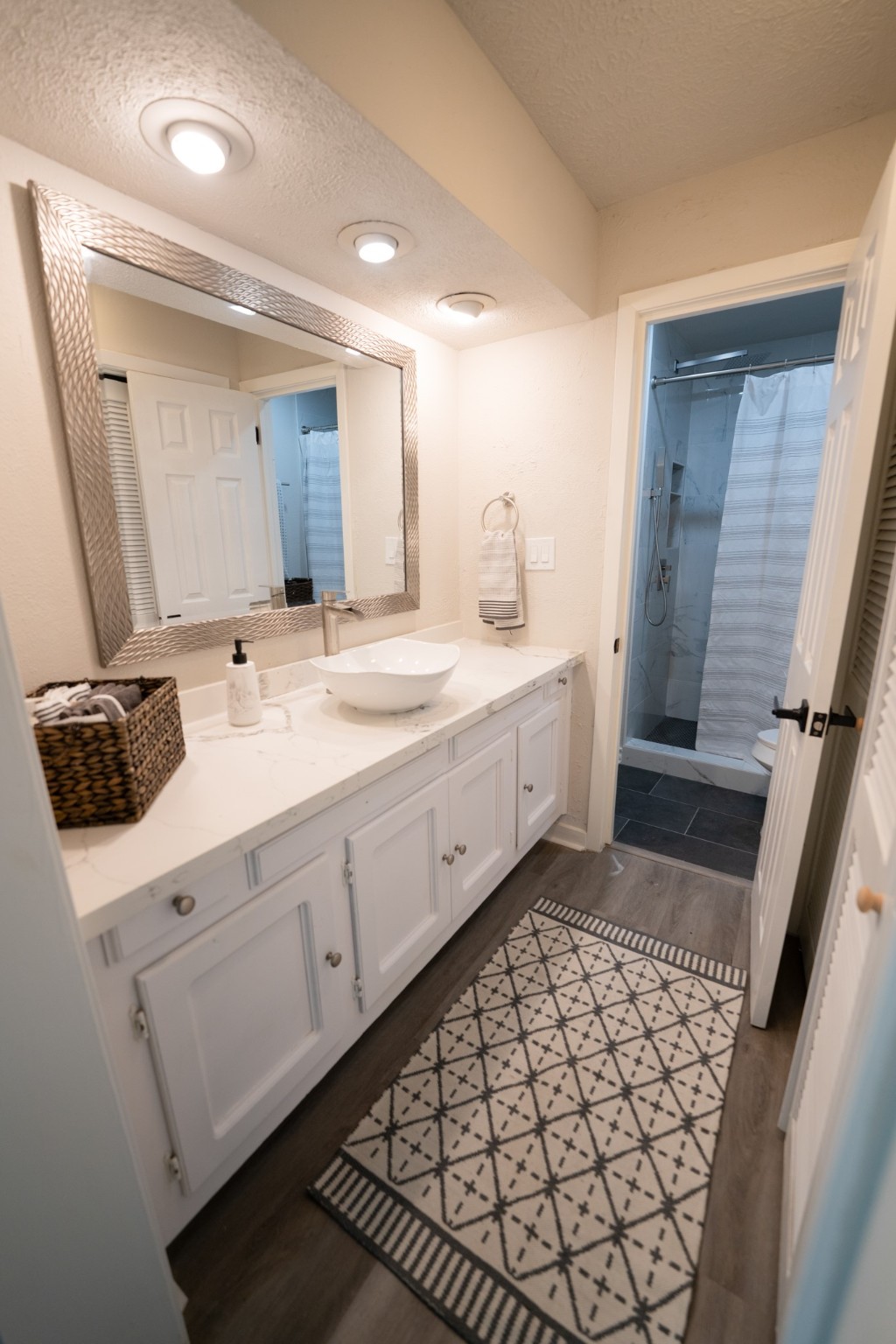 2145 16th Street Hempstead, TX 77445 - Photo 19 of 43 a bathroom with a sink and a mirror