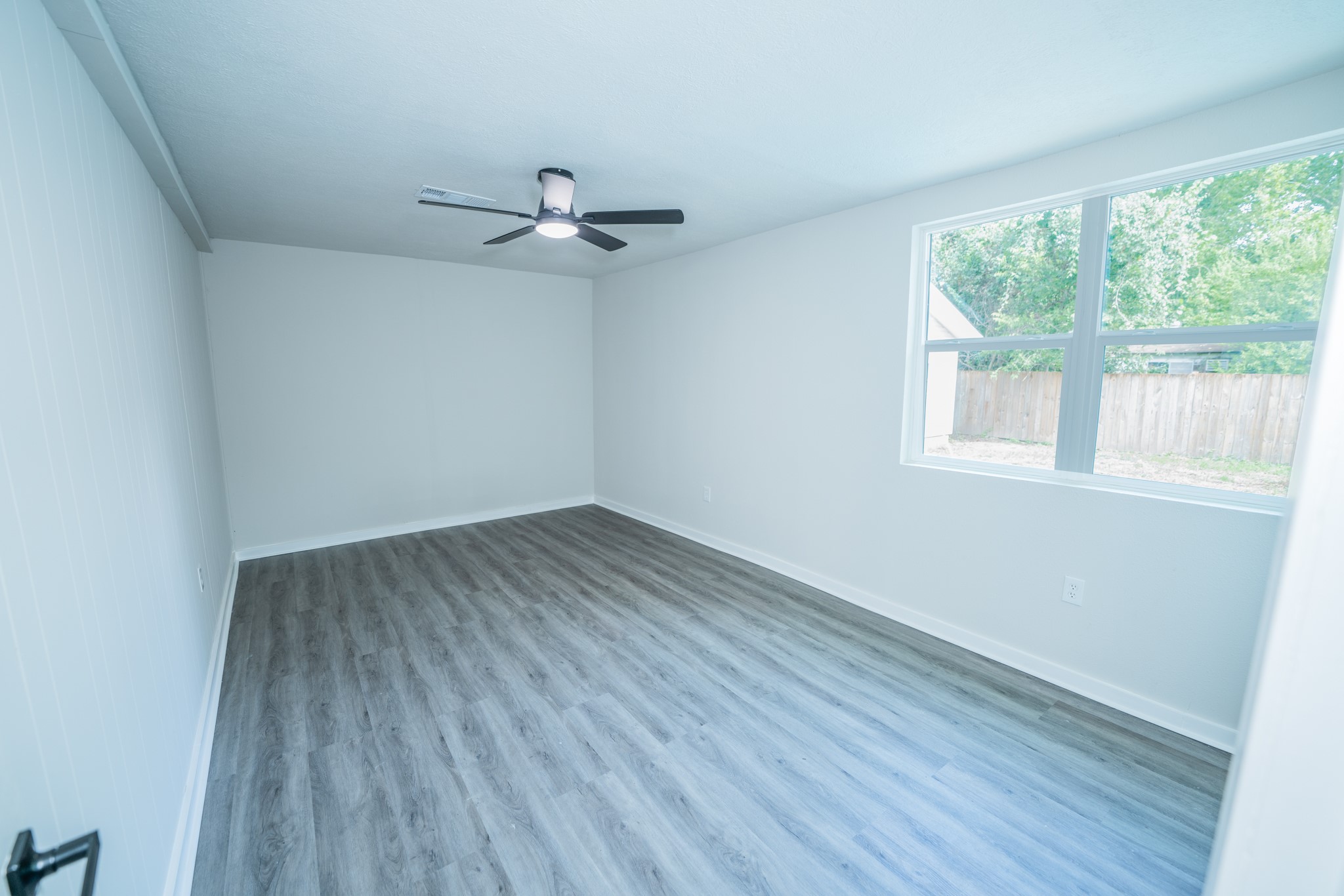 2145 16th Street Hempstead, TX 77445 - Photo 29 of 43 wooden floor in an empty room with a window