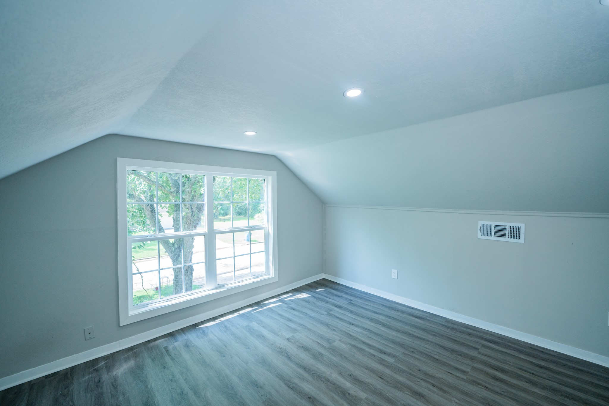 2145 16th Street Hempstead, TX 77445 - Photo 32 of 43 an empty room with wooden floor and windows