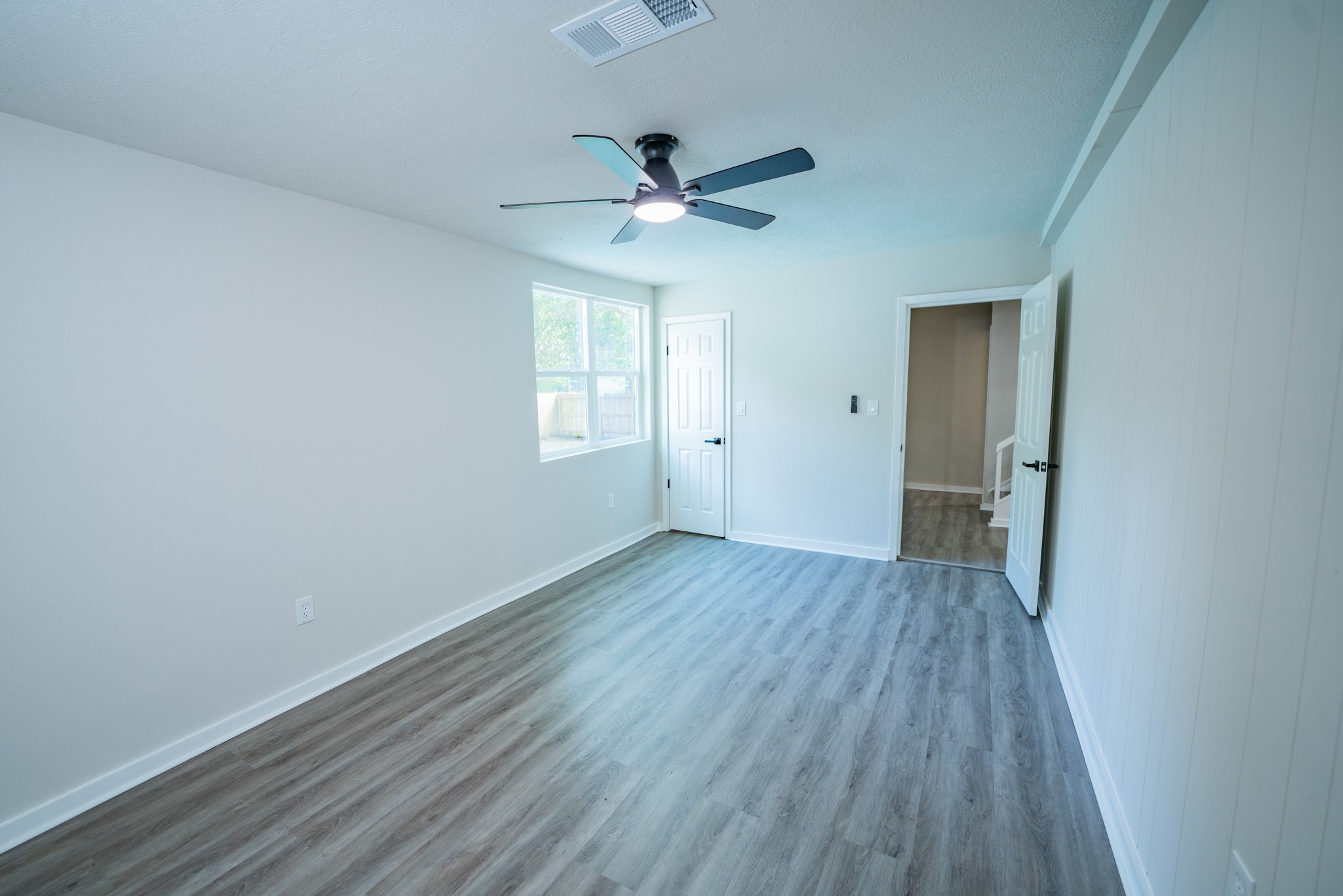 2145 16th Street Hempstead, TX 77445 - Photo 34 of 43 an empty room with wooden floor a ceiling fan and closet