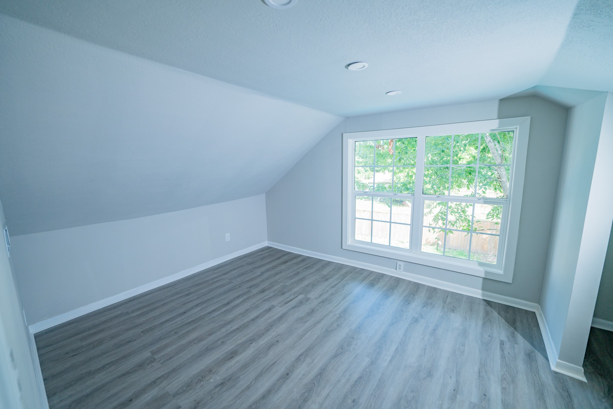 2145 16th Street Hempstead, TX 77445 - Photo 36 of 43 a view of an empty room with wooden floor and a window
