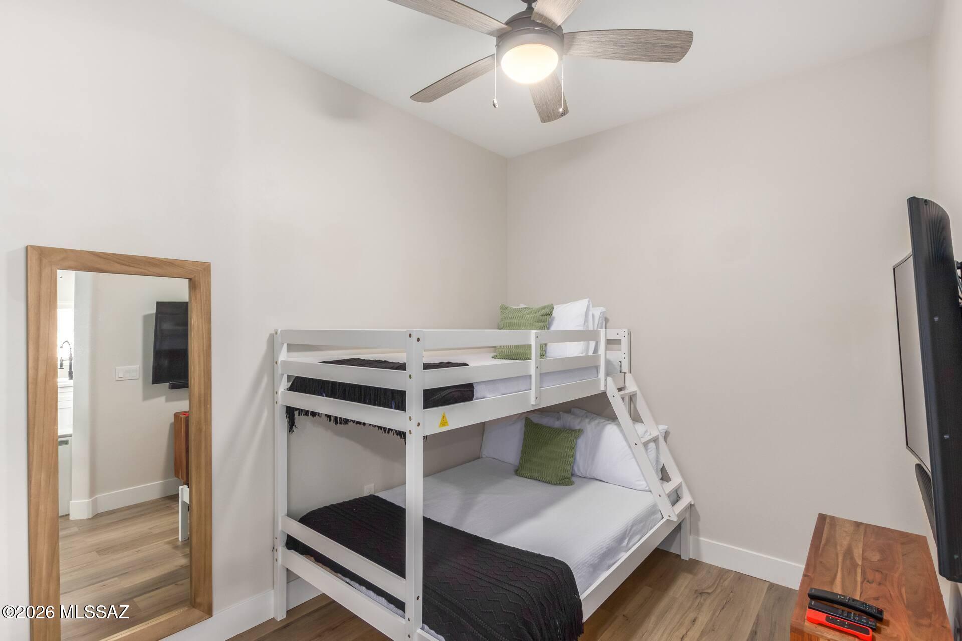 2036 East River Road, Unit 104 Tucson, AZ 85718 - Photo 14 of 23 a bedroom with a bunk bed and a desk