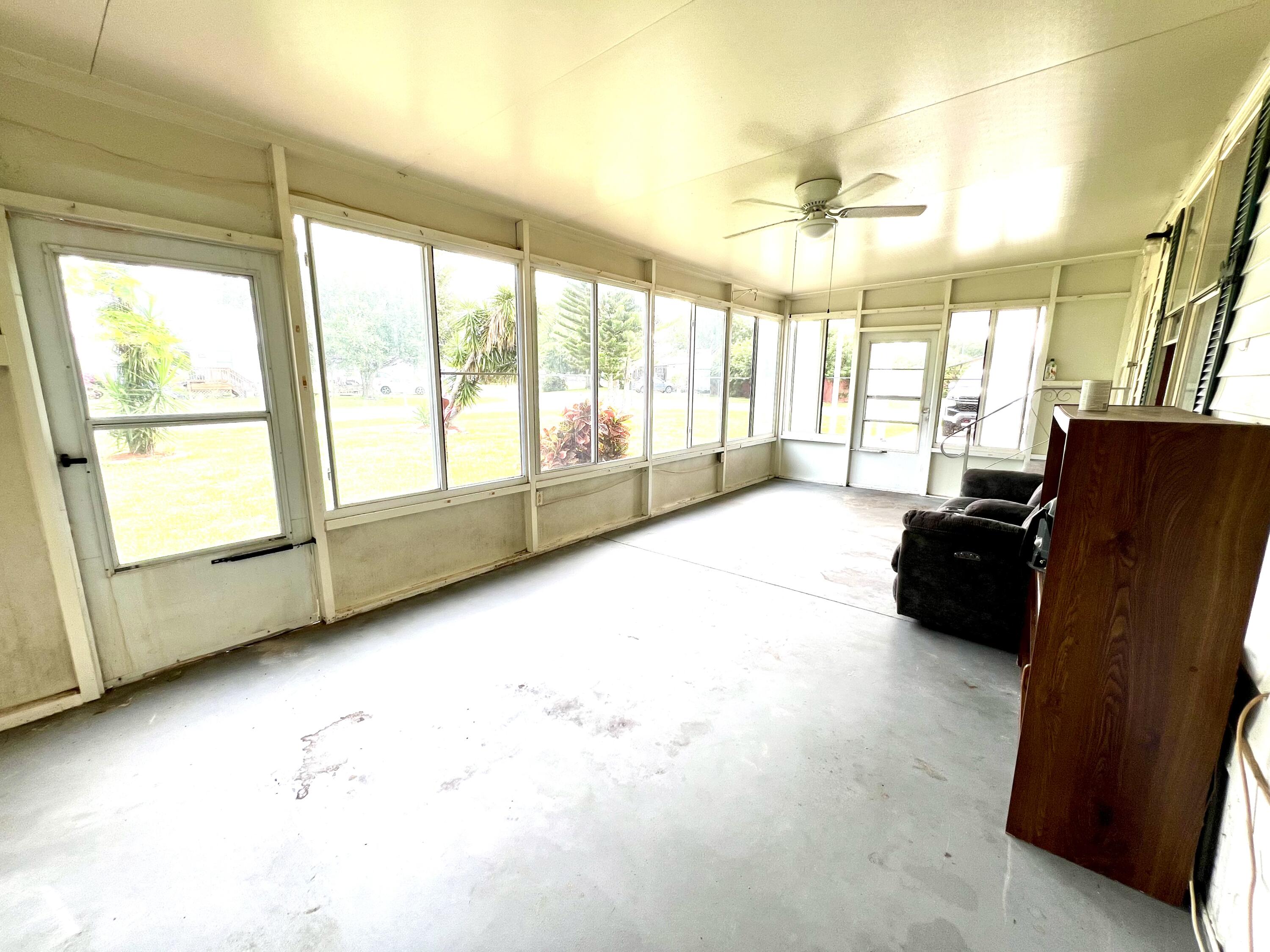 1303 Jordan Loop Okeechobee, FL 34974 - Photo 13 of 33 a spacious bedroom with a large bed and a large window