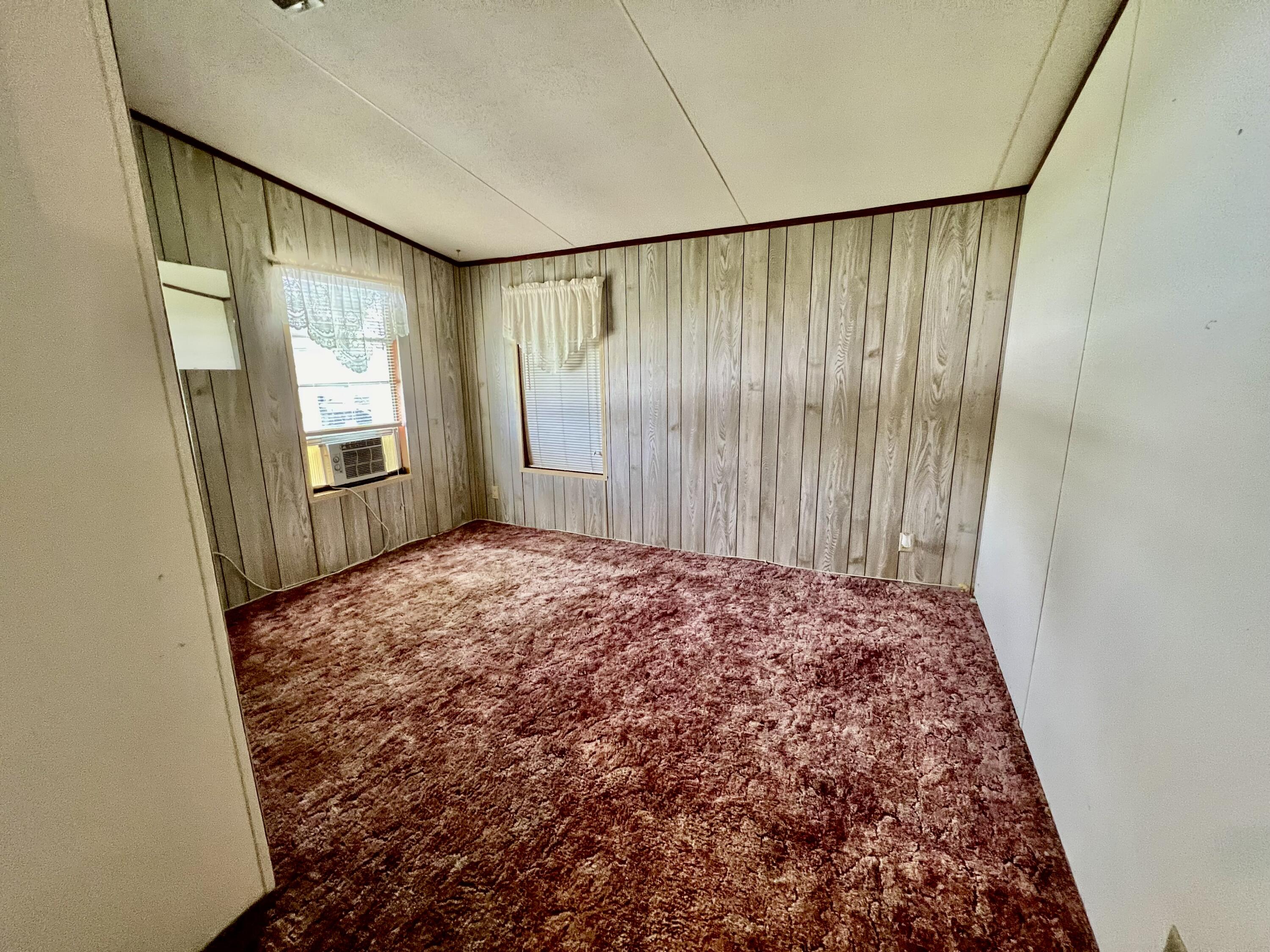 1303 Jordan Loop Okeechobee, FL 34974 - Photo 23 of 33 a view of a big room with windows and wardrobe