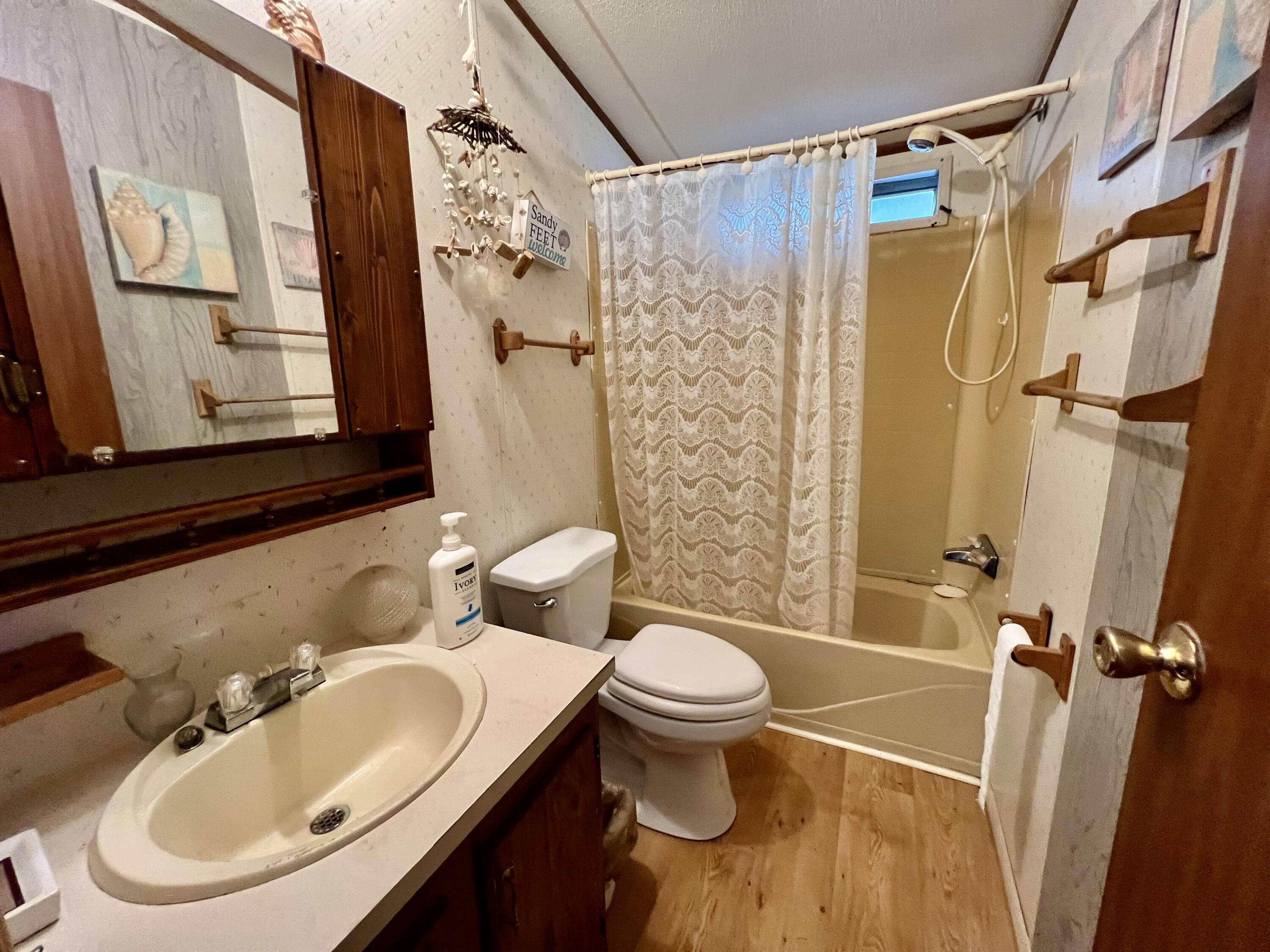 1303 Jordan Loop Okeechobee, FL 34974 - Photo 24 of 33 a bathroom with a sink toilet and shower