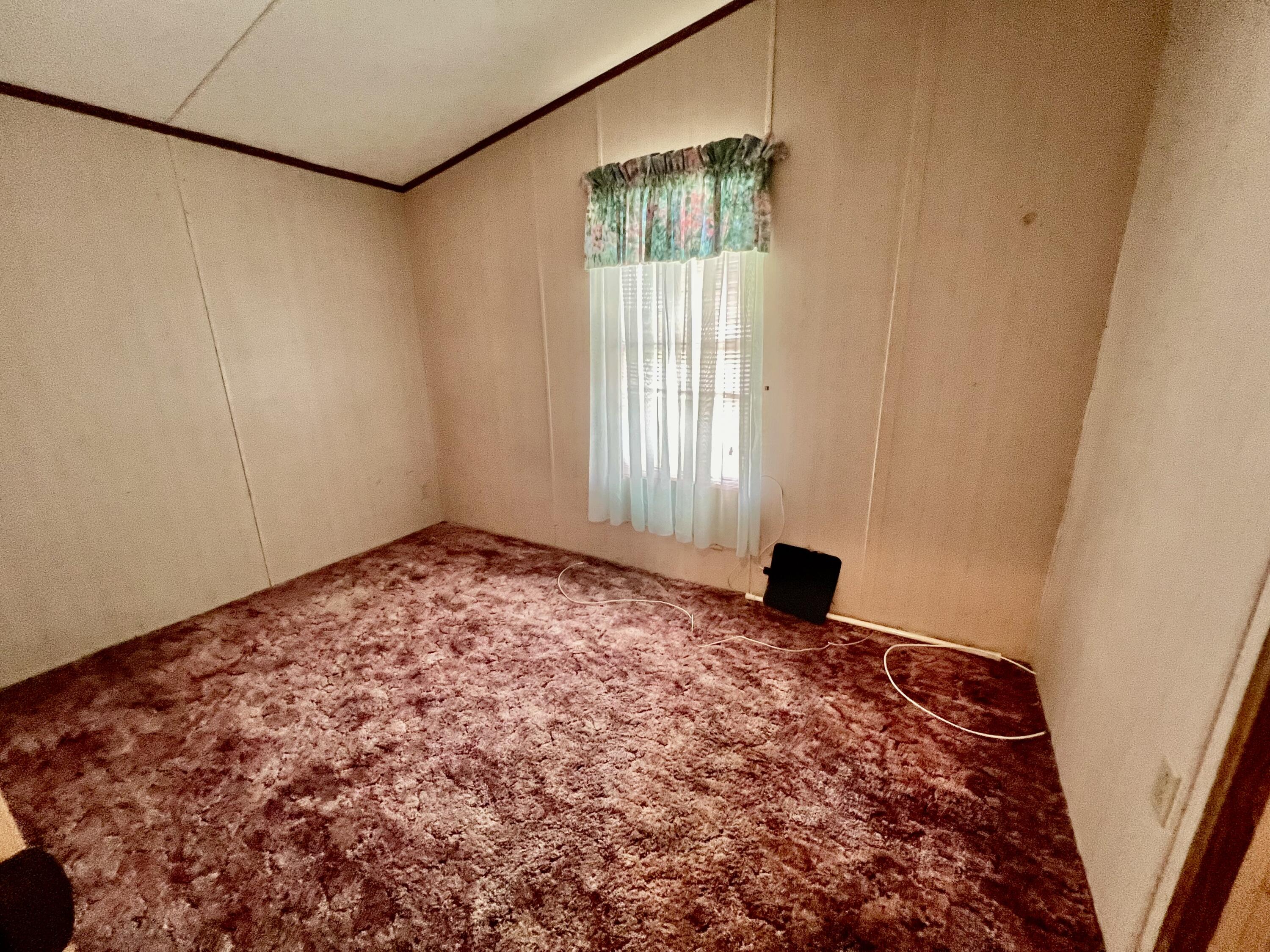 1303 Jordan Loop Okeechobee, FL 34974 - Photo 25 of 33 a view of a big room with window and wooden floor