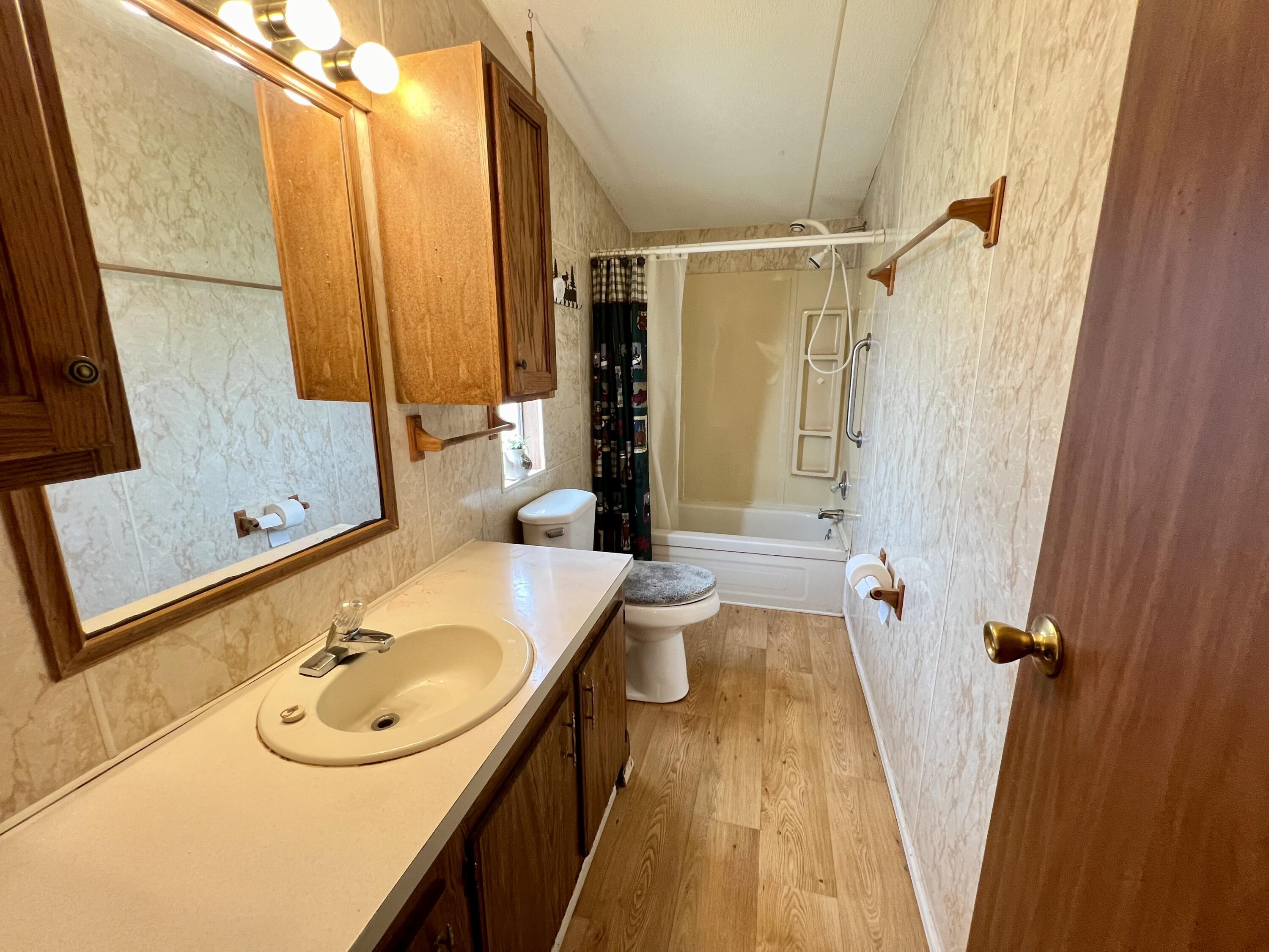 1303 Jordan Loop Okeechobee, FL 34974 - Photo 28 of 33 a bathroom with a sink and a tub