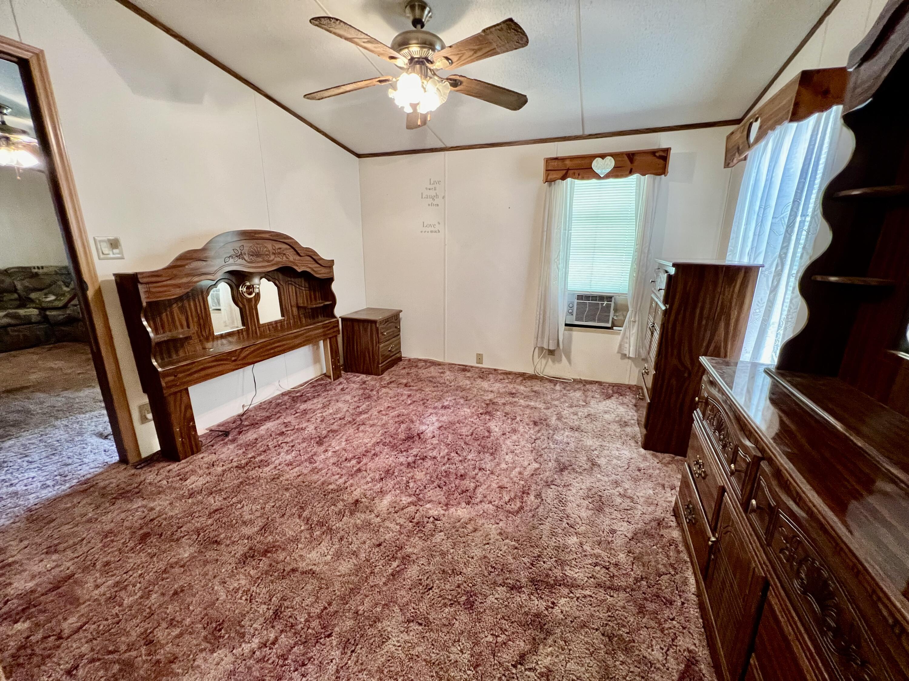 1303 Jordan Loop Okeechobee, FL 34974 - Photo 29 of 33 a bedroom with furniture and wooden floor
