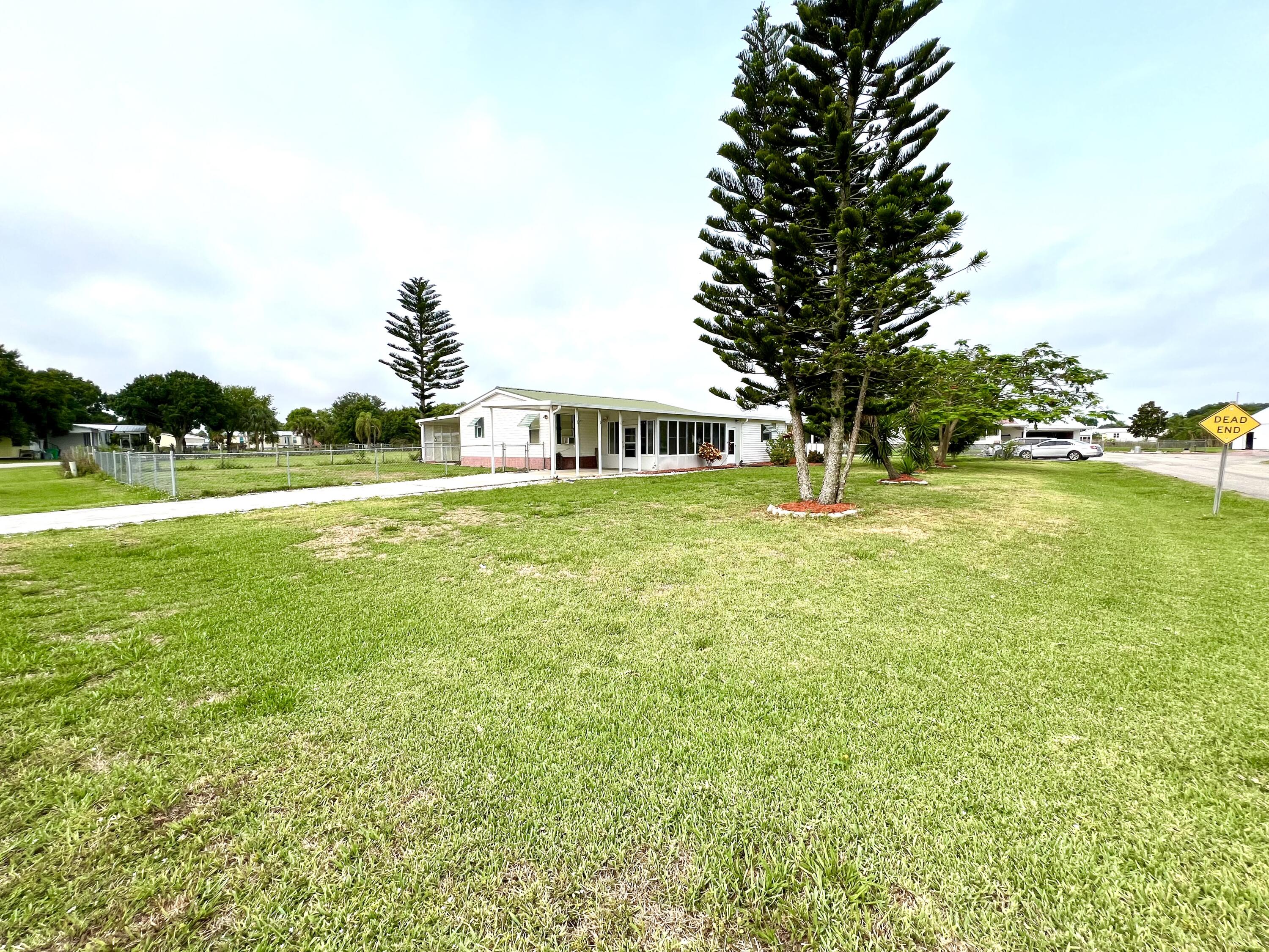 1303 Jordan Loop Okeechobee, FL 34974 - Photo 3 of 33 a view of a large garden with a house in the background