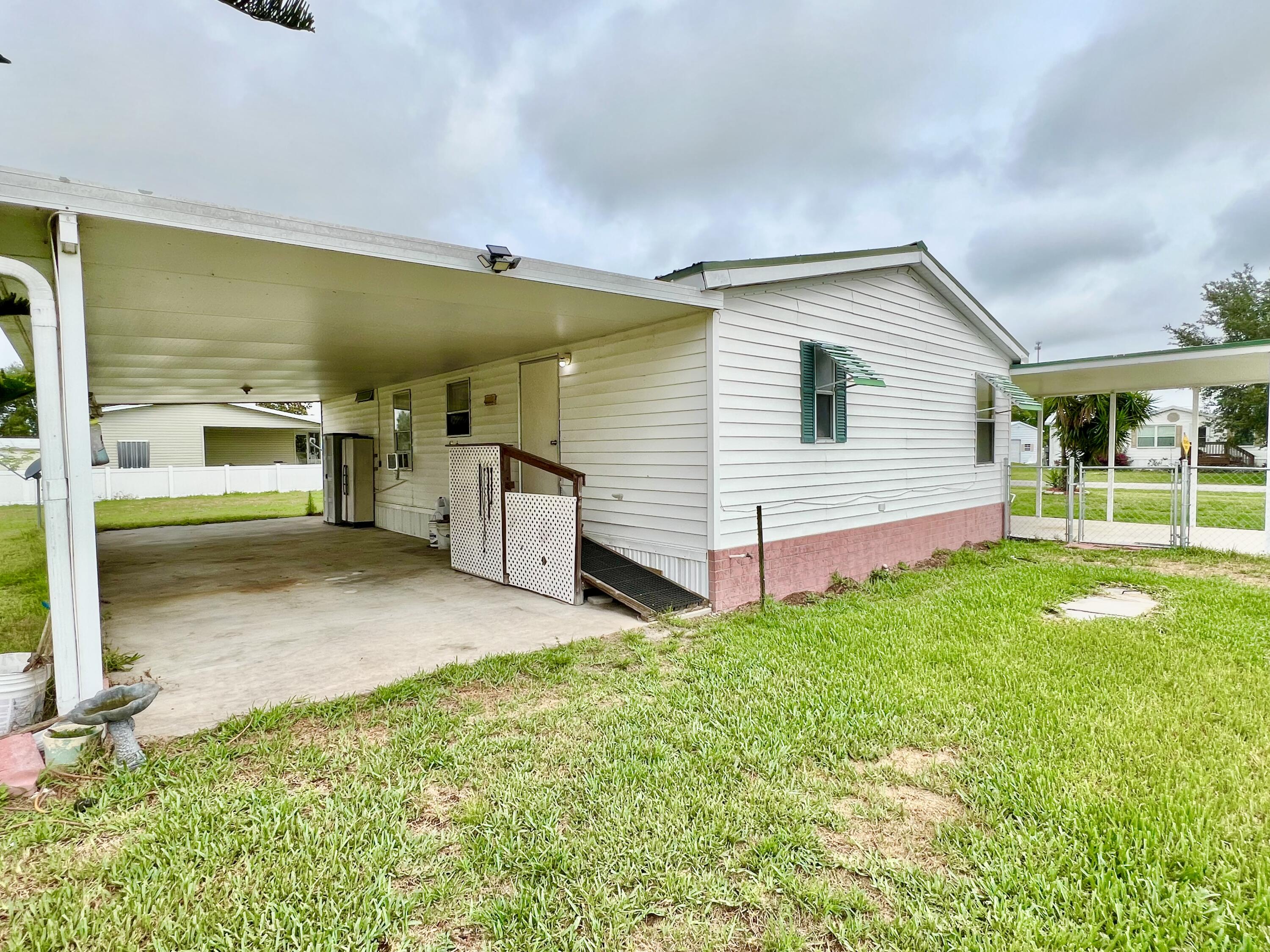 1303 Jordan Loop Okeechobee, FL 34974 - Photo 31 of 33 a view of a house with backyard and porch