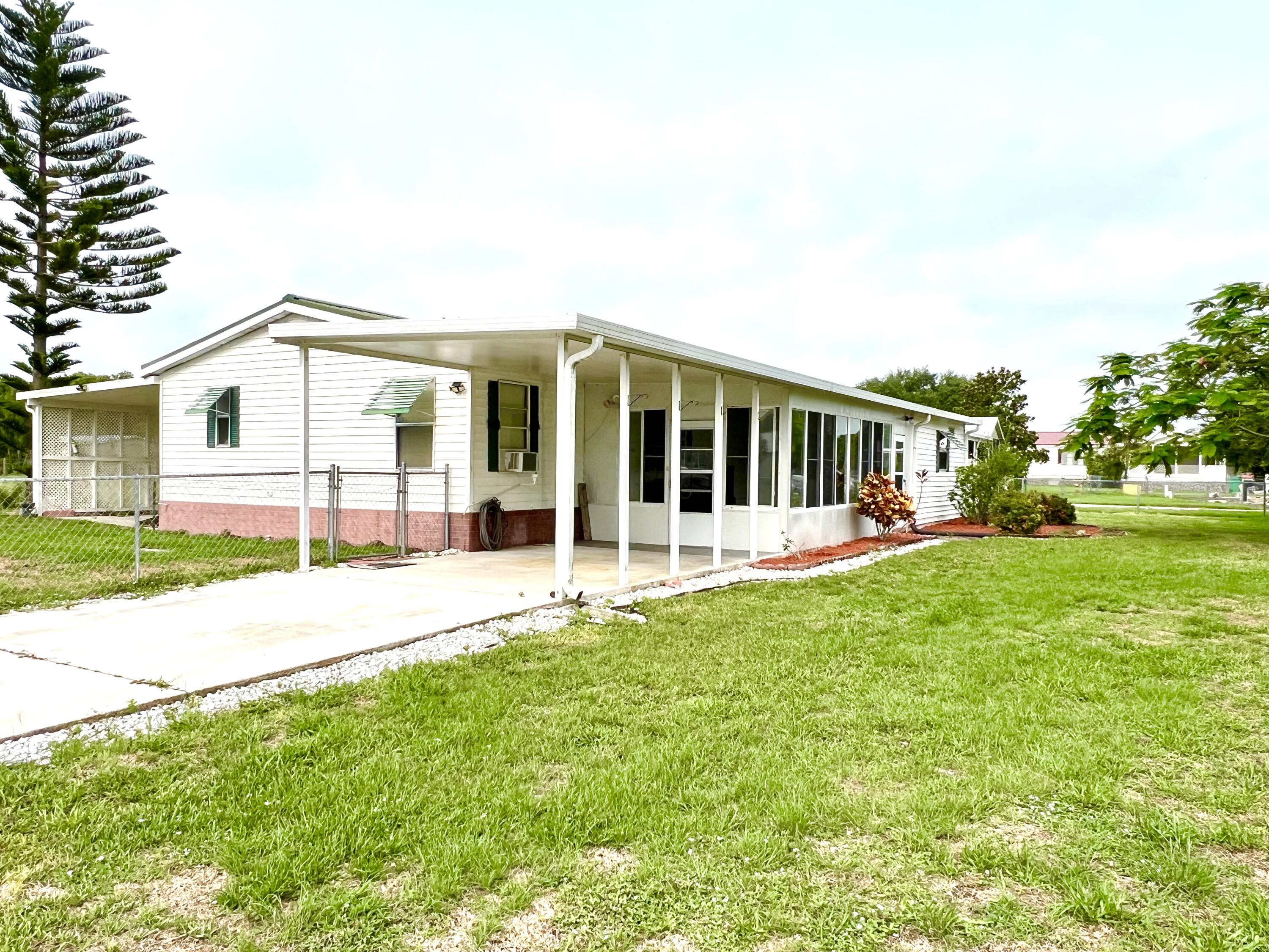 1303 Jordan Loop Okeechobee, FL 34974 - Photo 5 of 33 a view of a house with backyard and porch