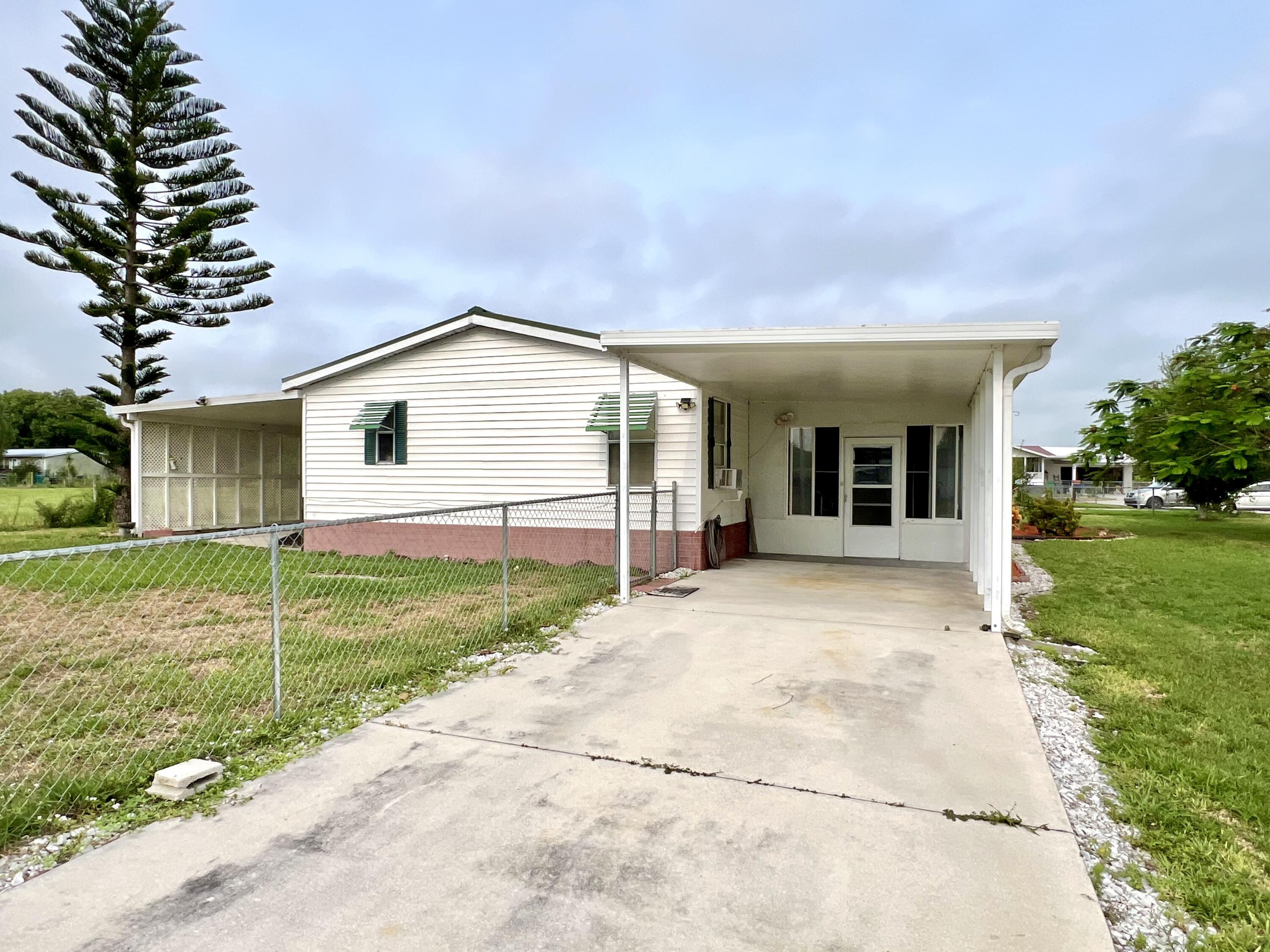 1303 Jordan Loop Okeechobee, FL 34974 - Photo 6 of 33 a view of a house with yard and a garden