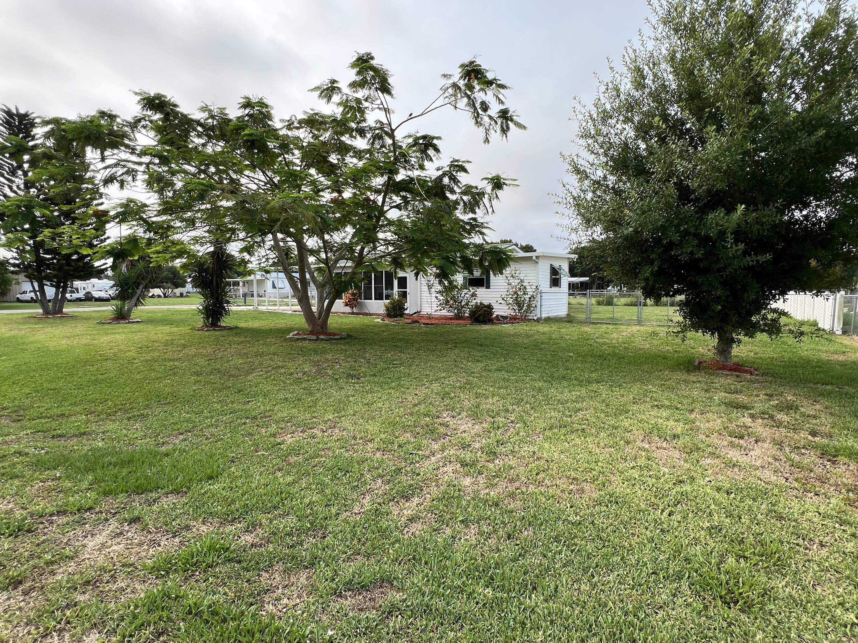 1303 Jordan Loop Okeechobee, FL 34974 - Photo 7 of 33 a view of a field with a tree