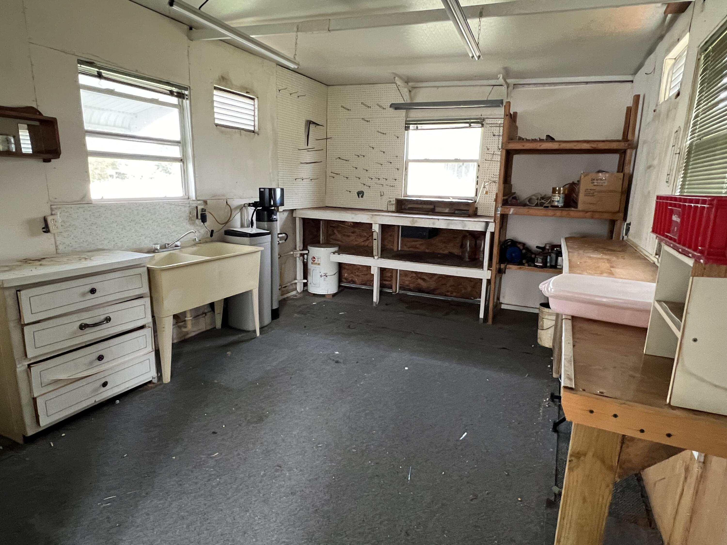 1303 Jordan Loop Okeechobee, FL 34974 - Photo 10 of 33 a room with furniture a window and flat screen tv