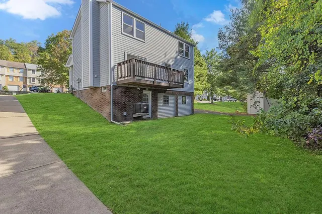 a view of a house with backyard and garden
