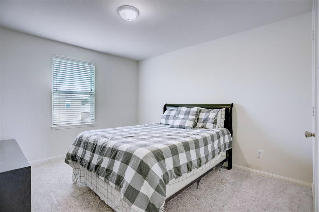 1303 Emerald Stone Drive Rosharon, TX 77583 - Photo 18 of 25 Large upstairs bedroom perfect for family members, guests, or multi-purpose living.