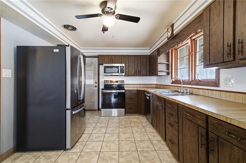 5626 5th Street Pittsburgh, PA 15236 - Photo 13 of 38 a large kitchen with stainless steel appliances granite countertop a refrigerator and a sink