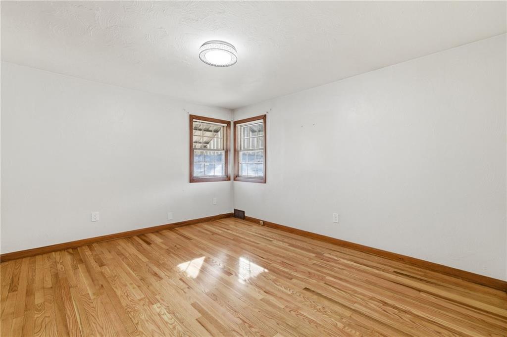 5626 5th Street Pittsburgh, PA 15236 - Photo 17 of 38 an empty room with wooden floor and windows