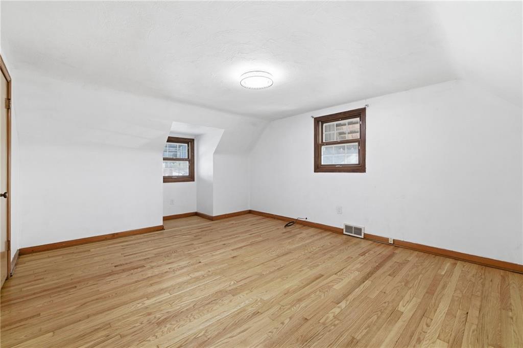 5626 5th Street Pittsburgh, PA 15236 - Photo 18 of 38 an empty room with wooden floor and windows