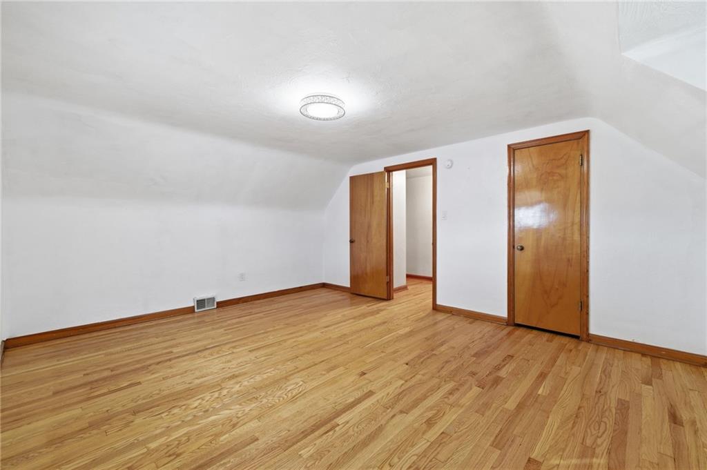 5626 5th Street Pittsburgh, PA 15236 - Photo 19 of 38 an empty room with wooden floor and closet