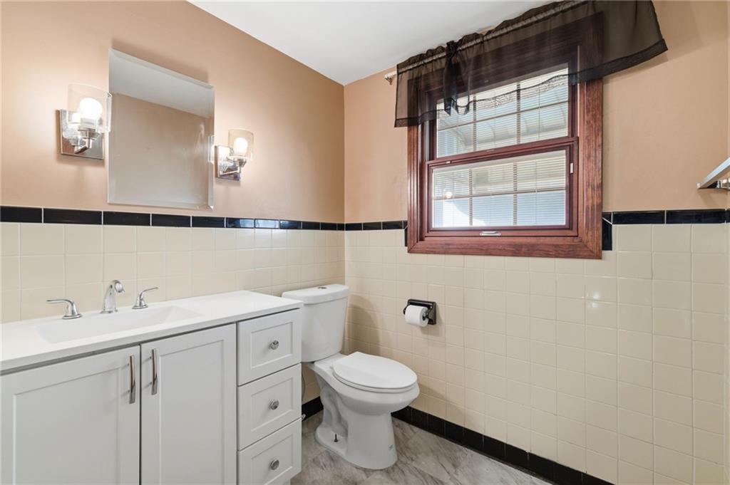 5626 5th Street Pittsburgh, PA 15236 - Photo 22 of 38 a bathroom with a toilet a sink and a mirror