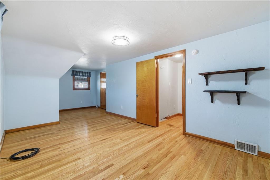 5626 5th Street Pittsburgh, PA 15236 - Photo 25 of 38 an empty room with wooden floor and windows