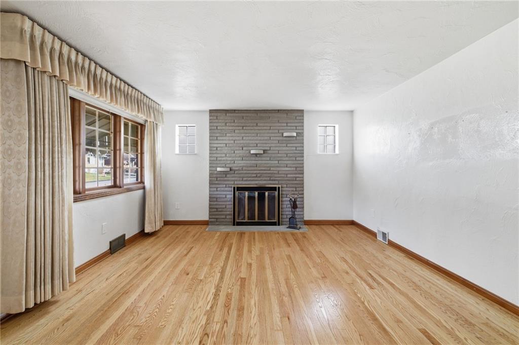 5626 5th Street Pittsburgh, PA 15236 - Photo 7 of 38 wooden floor fireplace and windows in an empty room
