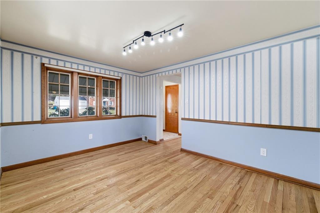 5626 5th Street Pittsburgh, PA 15236 - Photo 8 of 38 a view of an empty room with wooden floor and a window