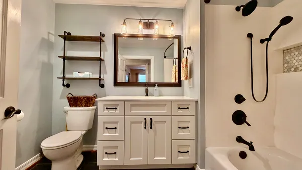 a bathroom with a toilet a sink and a mirror