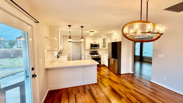 a view of kitchen and dining room with wooden floor