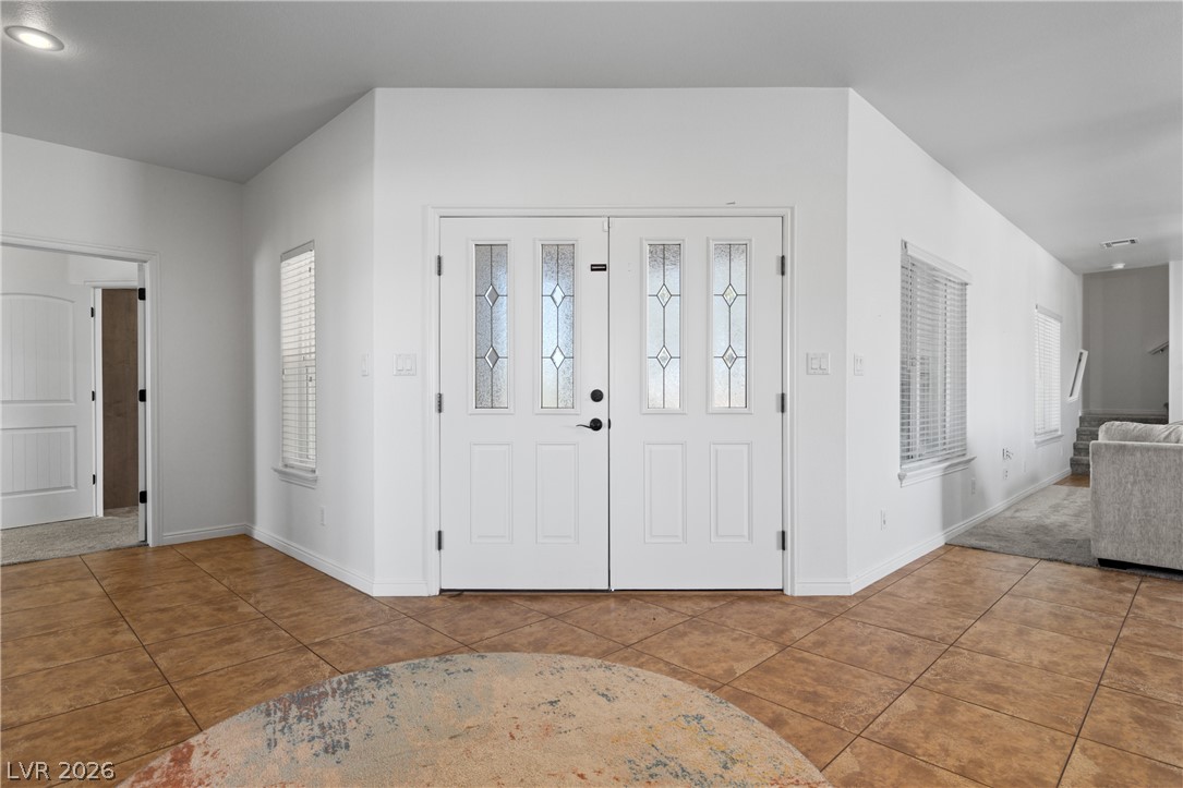 575 Gann Avenue Logandale, NV 89021 - Photo 3 of 75 A welcoming entry features decorative glass panel double doors and durable tile flooring.