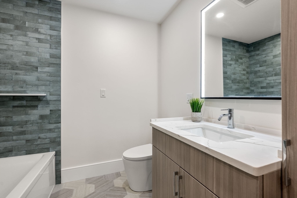 527 East 7th Street, Unit 1 Boston, MA 02127 - Photo 12 of 24 a bathroom with a sink a toilet and shower