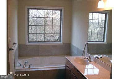6721 Ridgecrest Road New Market, MD 21774 - Photo 6 of 17 a bathroom with a granite countertop sink and a bathtub
