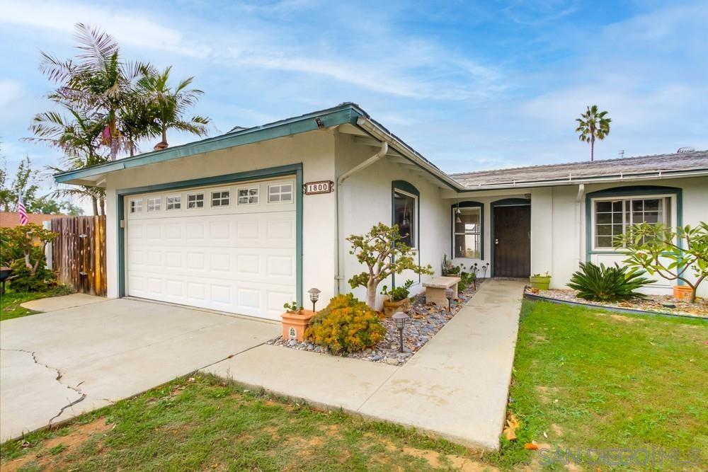 1800 Guevara Road Carlsbad, CA 92008 - Photo 1 of 29 a front view of a house with a yard outdoor seating and garage