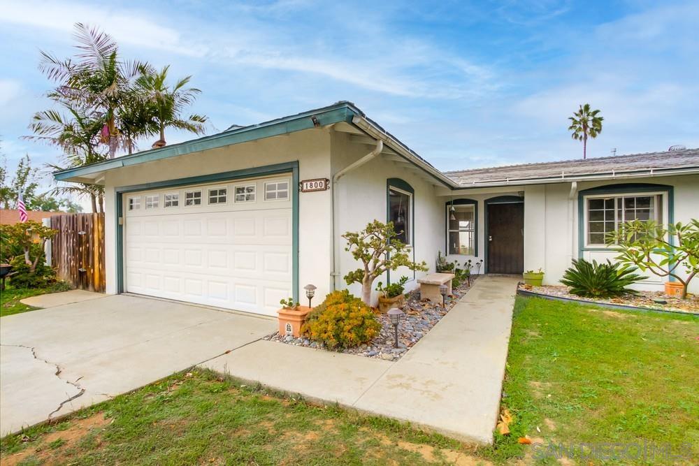 a front view of a house with a yard outdoor seating and garage