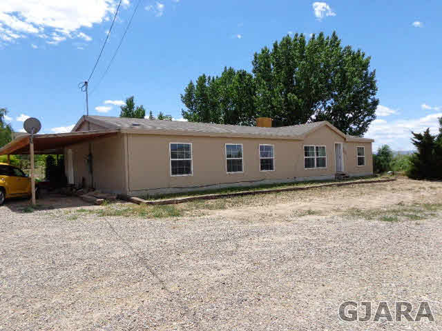 3551 E Road Palisade, CO 81526 - Photo 1 of 8 a house with yard in front of it