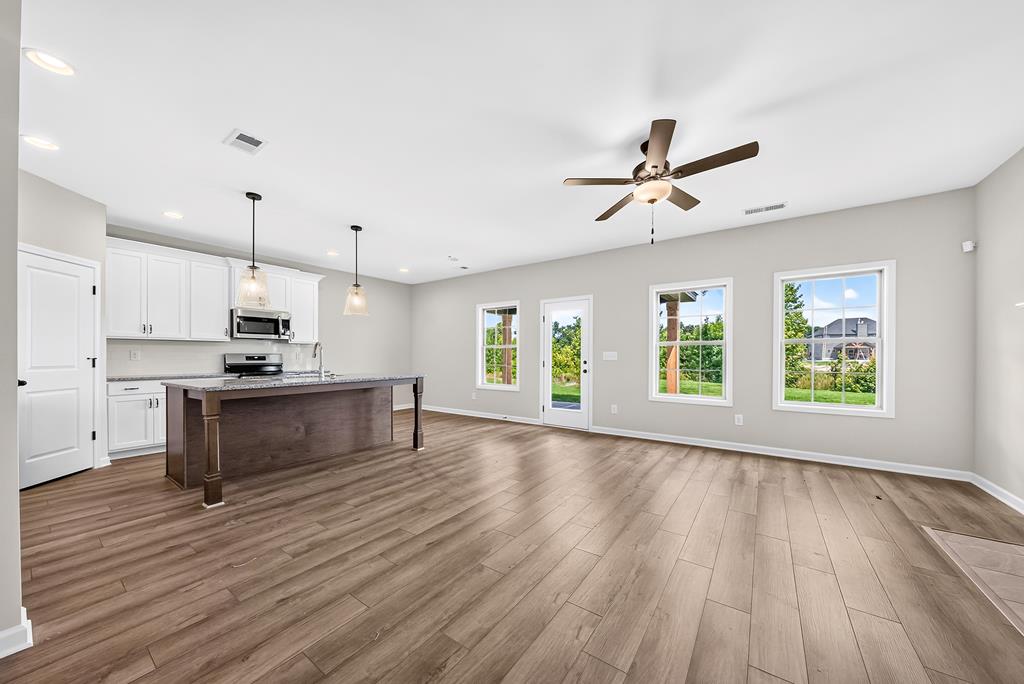 6 Liberty Place Fort Mitchell, AL 36856 - Photo 6 of 27 a kitchen with kitchen island wooden floors appliances and window