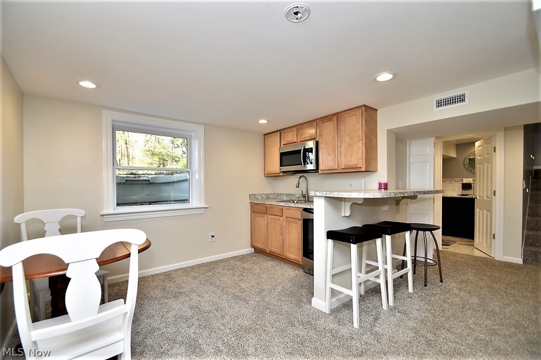 8790 Avery Road Broadview Heights, OH 44147 - Photo 26 of 35 The lower level also has a wet bar with a microwave, beverage fridge, and bar area perfect for entertaining or when you just need a little separation from the rest of the household during quarantine.