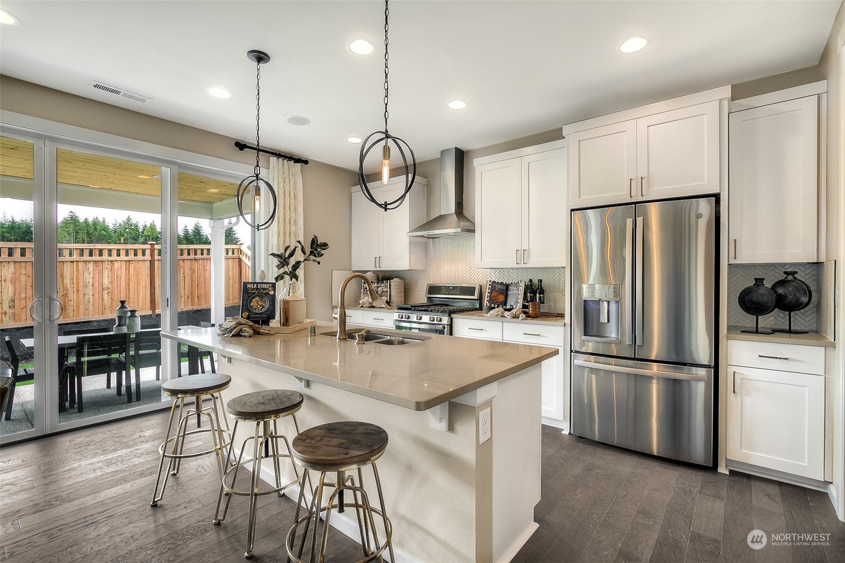10304 Balto Road Northwest, Unit 37 Silverdale, WA 98383 - Photo 12 of 21 a kitchen with stainless steel appliances granite countertop a stove a refrigerator a kitchen island a dining table and chairs