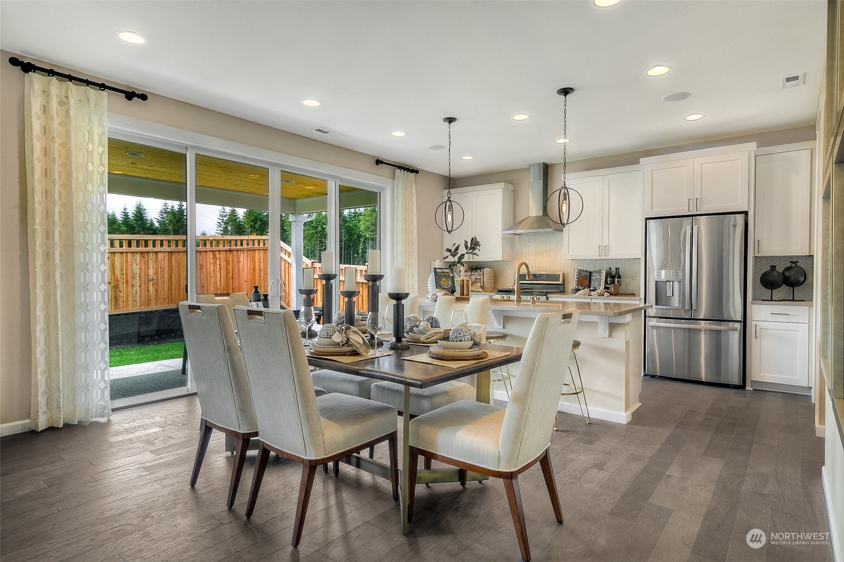 10304 Balto Road Northwest, Unit 37 Silverdale, WA 98383 - Photo 7 of 21 a dining room with stainless steel appliances furniture a large window and a kitchen view