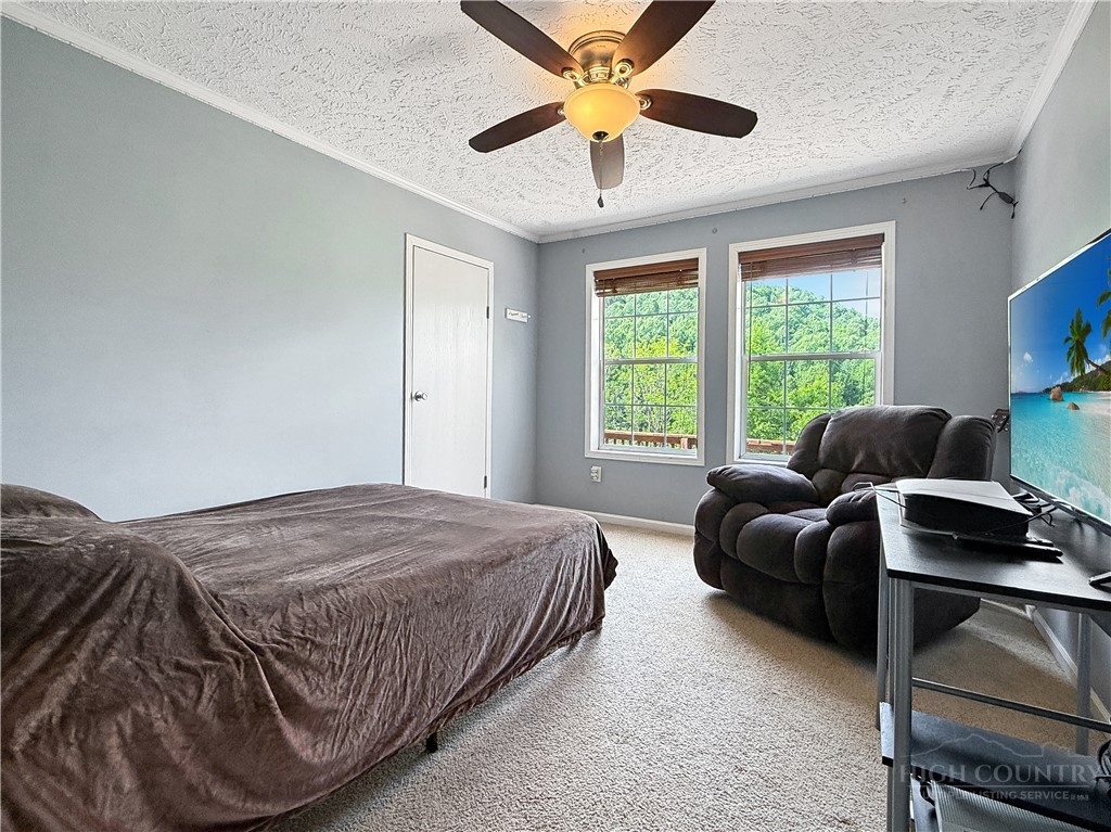 1173 Hopewell Church Road Boone, NC 28607 - Photo 16 of 39 a bedroom with a bed and a large window