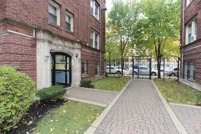 a view of a brick house with a yard